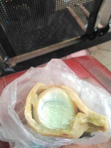 Lady in shock after finding whole boiled egg inside meat pie