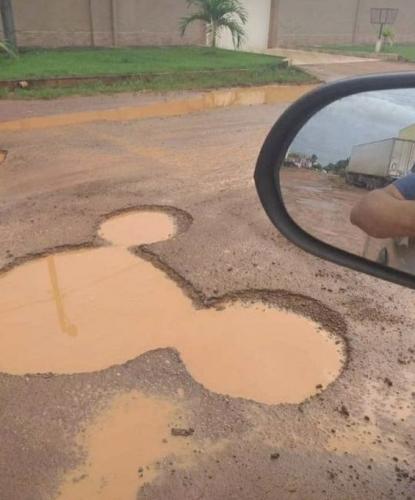 Funny reactions as man spots ”Mickey Mouse” pothole in Lagos (Photos)